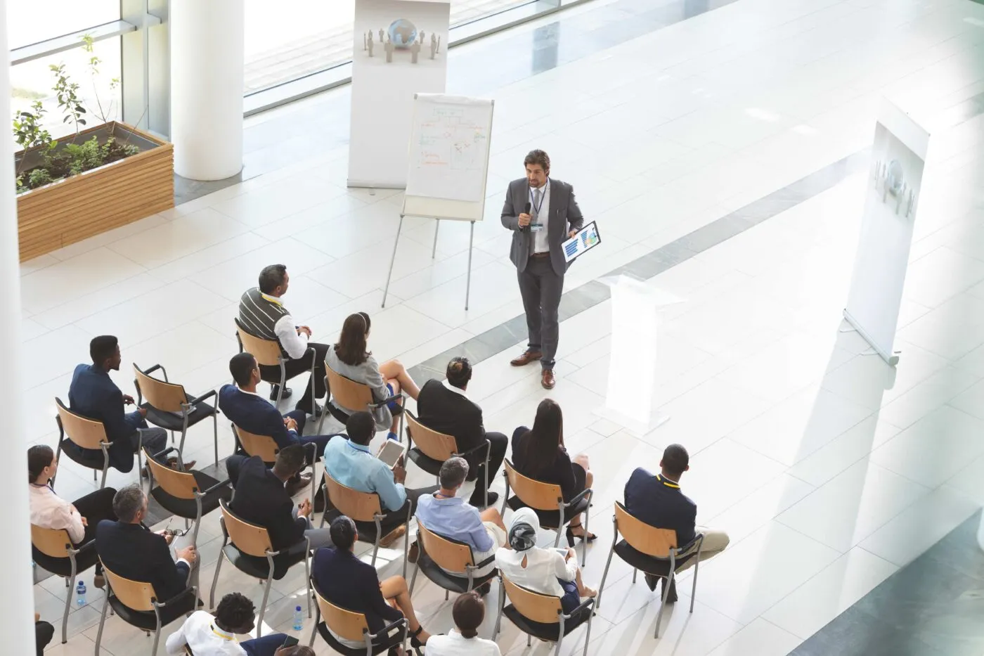 Male Speaker With Digital Tablet Speaks In A Business Seminar