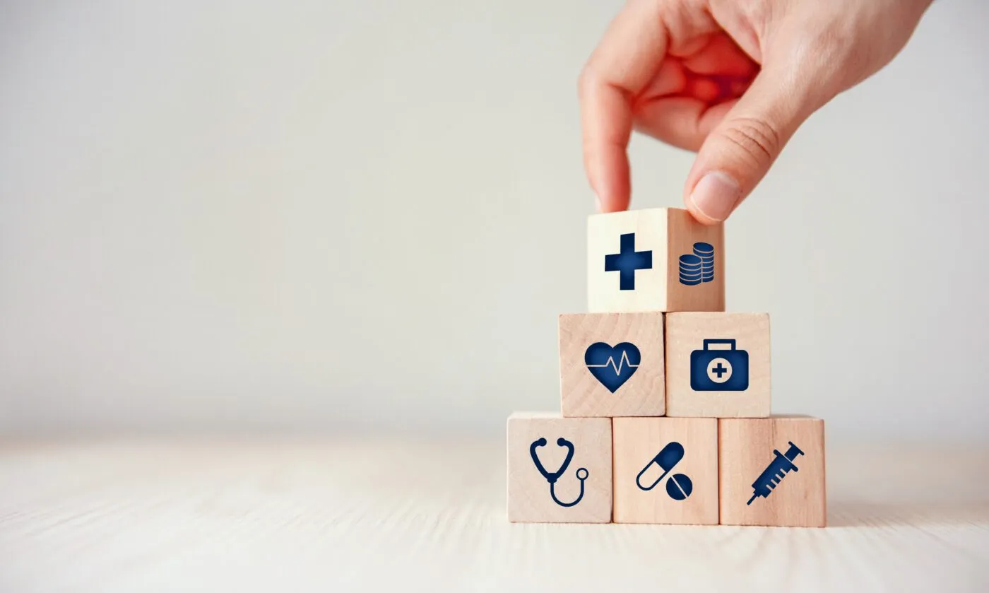 Health Insurance Concept, Hand Arranging Wood Cube Stacking With