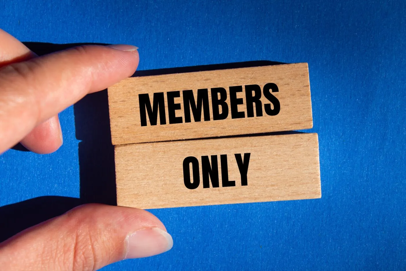 Members,Only,Message,Written,On,Wooden,Blocks,With,Blue,Background.