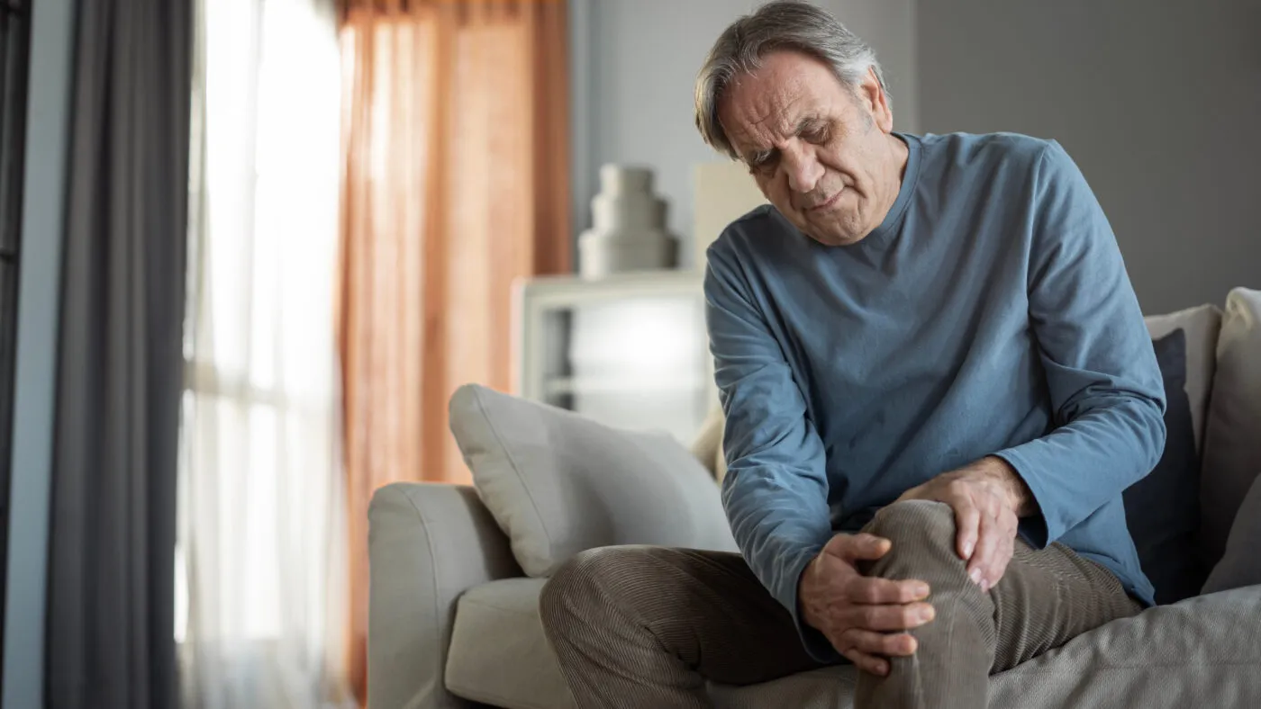 Old Man Suffering From Knee Pain